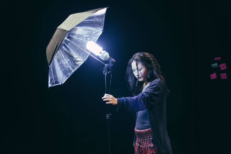 photo of girl holding a lamp in the dark