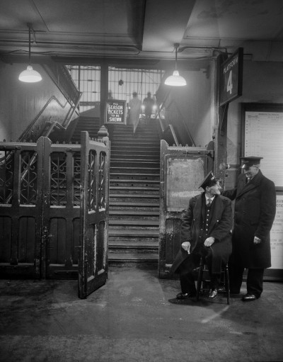Ticket Collectors, London (1962) by Evelyn Hofer